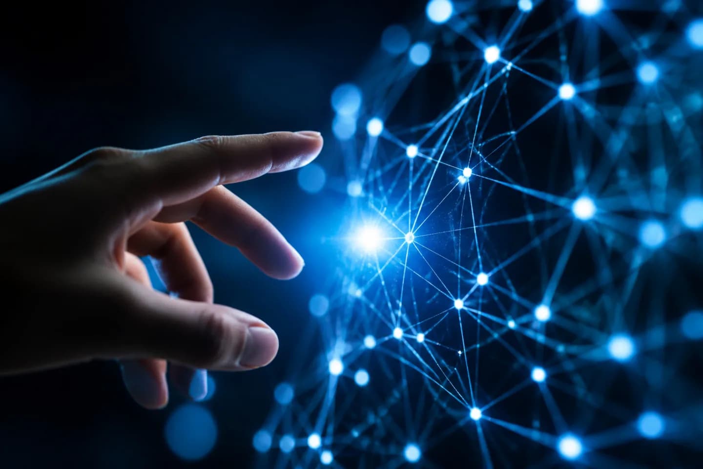 A human hand reaching toward a glowing blue AI neural network visualization